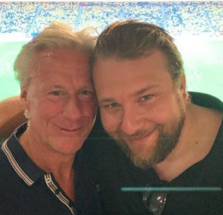 Father and son are close to eachother.